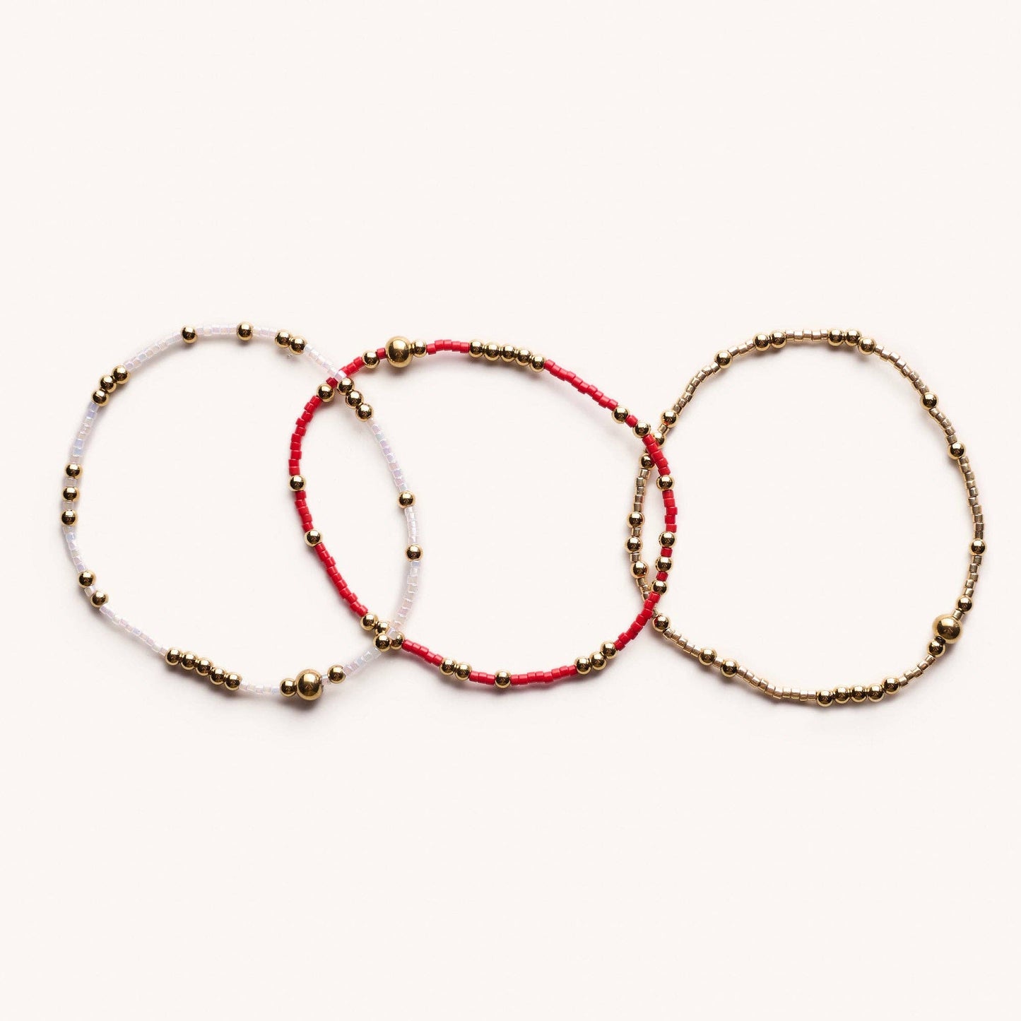 Three beaded bracelets on a white background