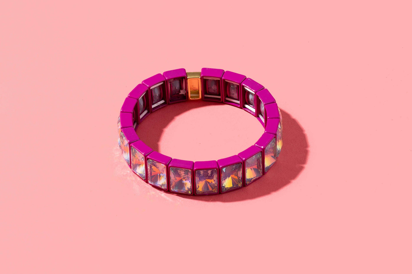 Multicolored gemstone bracelet on a pink background