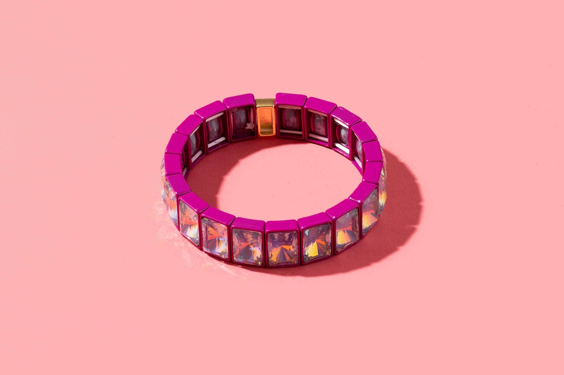 Multicolored gemstone bracelet on a pink background